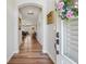 Inviting hallway with hardwood floors, neutral walls, arched entryway, and charming decor at 67 Narrowleaf Ln, Dallas, GA 30157