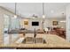 Open kitchen showcasing granite countertops, stainless steel sink, and seamless connection to the living room and dining area at 67 Narrowleaf Ln, Dallas, GA 30157