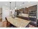 Spacious kitchen island with granite countertops, stainless steel appliances, and stylish pendant lighting at 67 Narrowleaf Ln, Dallas, GA 30157