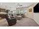 Comfortable living room with plush seating, carpeted floor, and a seamless transition to the modern kitchen at 67 Narrowleaf Ln, Dallas, GA 30157