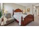 Comfortable main bedroom with traditional furnishings, a plush bed, and a cozy reading chair at 67 Narrowleaf Ln, Dallas, GA 30157