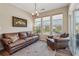 Bright sunroom with comfortable seating, natural light, and views of the surrounding landscape at 67 Narrowleaf Ln, Dallas, GA 30157
