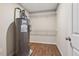 Utility room featuring a water heater, shelving, and wood-look flooring at 67 Narrowleaf Ln, Dallas, GA 30157