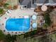 Backyard aerial view of an in-ground pool, patio with seating, and lush landscaping at 750 Maggie Nw Ct, Kennesaw, GA 30144