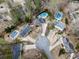 Aerial view of homes in a cul-de-sac, showcasing the surrounding mature trees and backyard pools at 750 Maggie Nw Ct, Kennesaw, GA 30144