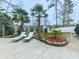 Inviting backyard featuring a concrete patio, lounge chairs, meticulous landscaping, and mature palm trees at 750 Maggie Nw Ct, Kennesaw, GA 30144