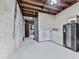 Unfinished basement with concrete walls, exposed beams, and a walkout door at 750 Maggie Nw Ct, Kennesaw, GA 30144