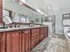 Elegant bathroom features a granite countertop, dual sinks, wood cabinets, and a glass-enclosed shower at 750 Maggie Nw Ct, Kennesaw, GA 30144