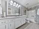 Well-lit bathroom featuring a large mirror, granite countertop, and tiled floors at 750 Maggie Nw Ct, Kennesaw, GA 30144