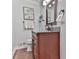 Cozy bathroom with modern vanity, decorative mirror, granite counter, and good lighting at 750 Maggie Nw Ct, Kennesaw, GA 30144