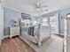 Comfortable bedroom featuring a ceiling fan, a large window, and hardwood floors at 750 Maggie Nw Ct, Kennesaw, GA 30144