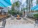 Charming brick patio with a cozy fire pit, surrounded by comfortable seating and lush landscaping at 750 Maggie Nw Ct, Kennesaw, GA 30144