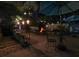Outdoor patio with a brick fire pit surrounded by seating and string lights for a cozy gathering space at 750 Maggie Nw Ct, Kennesaw, GA 30144