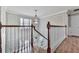 Bright foyer featuring a chandelier, white trim, and hardwood floors as seen from the second floor at 750 Maggie Nw Ct, Kennesaw, GA 30144