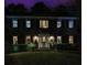 Inviting brick home at night with a manicured lawn, trimmed hedges, and illuminated windows at 750 Maggie Nw Ct, Kennesaw, GA 30144