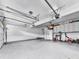 Well-lit garage with epoxy flooring, storage cabinets, and plenty of space for parking and hobbies at 750 Maggie Nw Ct, Kennesaw, GA 30144