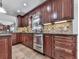 Updated kitchen with stainless steel appliances, granite countertops, and custom tiled backsplash at 750 Maggie Nw Ct, Kennesaw, GA 30144