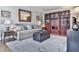 Comfortable living room features a sofa, ottoman, accent tables, lamps and a large decorative mirror at 750 Maggie Nw Ct, Kennesaw, GA 30144