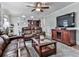 Comfortable living room with hardwood floors, a modern TV, cherry cabinet and leather furniture at 750 Maggie Nw Ct, Kennesaw, GA 30144
