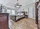 Spacious main bedroom features a tray ceiling, ceiling fan, hardwood floors, and large windows at 750 Maggie Nw Ct, Kennesaw, GA 30144