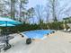 Backyard pool surrounded by lounge chairs and a patio area at 750 Maggie Nw Ct, Kennesaw, GA 30144