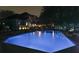 Beautiful backyard pool at night with a view of the home and ambient lighting at 750 Maggie Nw Ct, Kennesaw, GA 30144