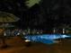 Relaxing pool at night with accent lighting surrounded by landscaping and trees for privacy at 750 Maggie Nw Ct, Kennesaw, GA 30144