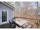 Back deck with view to wooded area featuring dining table and chairs at 802 Eagle Glen Xing, Woodstock, GA 30189