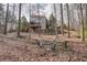 A relaxing backyard with a fire pit and seating area surrounded by mature trees, perfect for outdoor gatherings at 802 Eagle Glen Xing, Woodstock, GA 30189