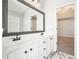 Double vanity featuring white cabinets, marble floors, and granite countertops at 802 Eagle Glen Xing, Woodstock, GA 30189