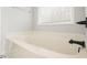 A spacious bathtub under a bright window at 802 Eagle Glen Xing, Woodstock, GA 30189