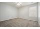 This bedroom has carpet flooring, a ceiling fan and window bringing in natural light at 802 Eagle Glen Xing, Woodstock, GA 30189
