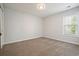 Bedroom features fresh paint, neutral carpet, and one bright window at 802 Eagle Glen Xing, Woodstock, GA 30189
