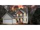 Charming two-story home with white siding, brick accents, black shutters, and well-maintained landscaping at 802 Eagle Glen Xing, Woodstock, GA 30189