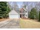 Beautiful home with a two car garage, driveway, lush lawn, and welcoming front entrance at 802 Eagle Glen Xing, Woodstock, GA 30189