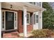 Charming brick home featuring a stylish black front door with glass detail and classic white trim at 802 Eagle Glen Xing, Woodstock, GA 30189