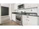 Updated kitchen featuring stainless steel appliances, granite countertops, and white cabinetry at 802 Eagle Glen Xing, Woodstock, GA 30189