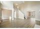 Open-concept living room featuring soaring ceilings, hardwood floors, and a staircase leading to the upper level at 802 Eagle Glen Xing, Woodstock, GA 30189