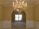 Spacious dining room featuring an elegant chandelier and framed by an arched entryway at 1211 Saxony Se Dr, Conyers, GA 30013
