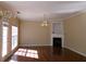 Spacious living room with a fireplace, ample natural light, and elegant chandelier lighting at 1211 Saxony Se Dr, Conyers, GA 30013