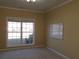 Bright living room with large window and neutral decor, ready for personalization at 1211 Saxony Se Dr, Conyers, GA 30013