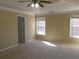 Generously sized main bedroom with tray ceiling and large windows, allowing ample sunlight at 1211 Saxony Se Dr, Conyers, GA 30013