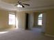 Spacious main bedroom featuring abundant natural light, tray ceiling, and neutral paint at 1211 Saxony Se Dr, Conyers, GA 30013