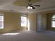 Spacious main bedroom featuring abundant natural light from two windows and tray ceiling at 1211 Saxony Se Dr, Conyers, GA 30013