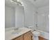 The bathroom features a single sink vanity, toilet, shower and tub combination with white walls and wood laminate flooring at 16 Montclair Ct, Cartersville, GA 30121
