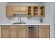 Bright kitchen with stainless steel dishwasher, sink, natural wood cabinetry and white countertops at 16 Montclair Ct, Cartersville, GA 30121