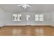 Spacious living room showcasing hardwood floors, large windows and an exit door at 16 Montclair Ct, Cartersville, GA 30121