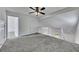 Upstairs loft area features carpet, white walls, and a railing that overlooks a window at 16 Montclair Ct, Cartersville, GA 30121