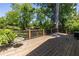 Spacious wood deck overlooks a lush green backyard and features a stained wood railing at 2628 White Oak Dr, Decatur, GA 30032