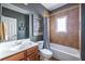 Bathroom with tile shower and tub combination plus brown vanity at 2628 White Oak Dr, Decatur, GA 30032